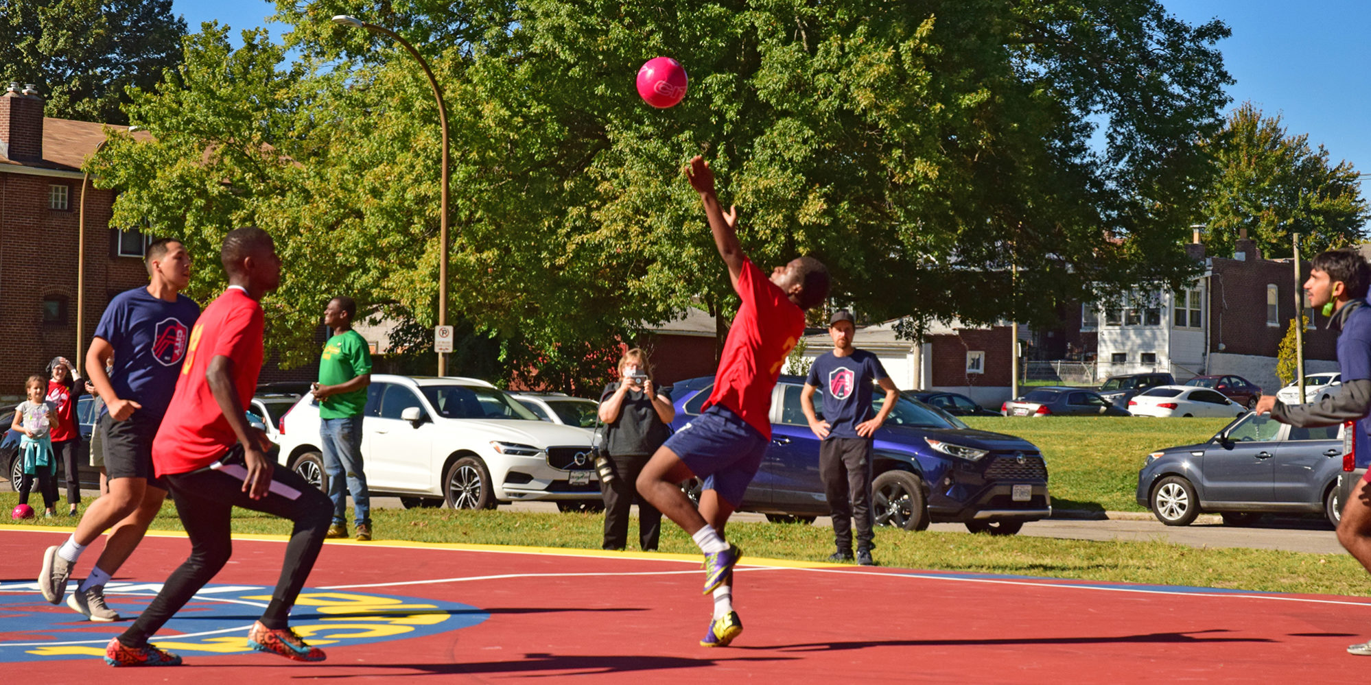 Young people play futsal on the court at Marquette Park in Dutchtown, St. Louis, MO.